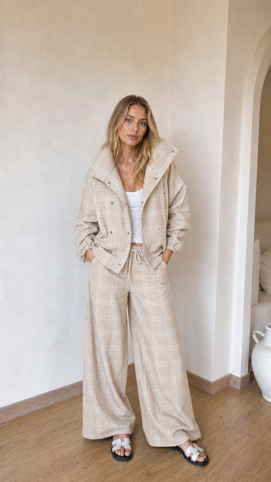 Model wearing beige cream plaid high-collar jacket and wide-leg matching set