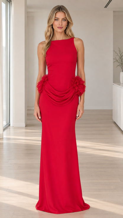 Front view of model wearing sleeveless red maxi gown with boat neck and draped floral hip details
