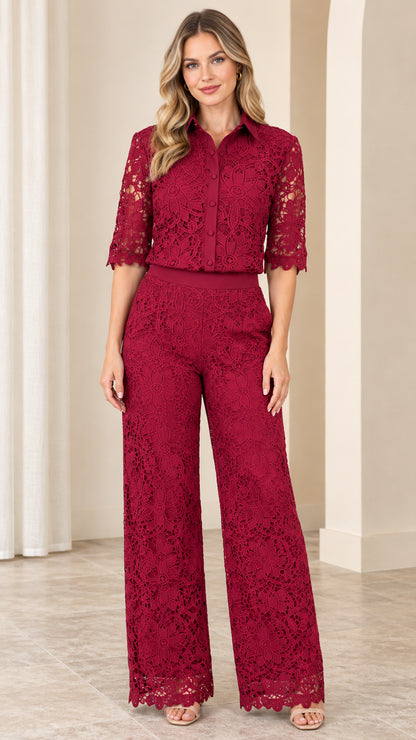 Front full-length view of woman wearing burgundy floral lace collared wide-leg jumpsuit