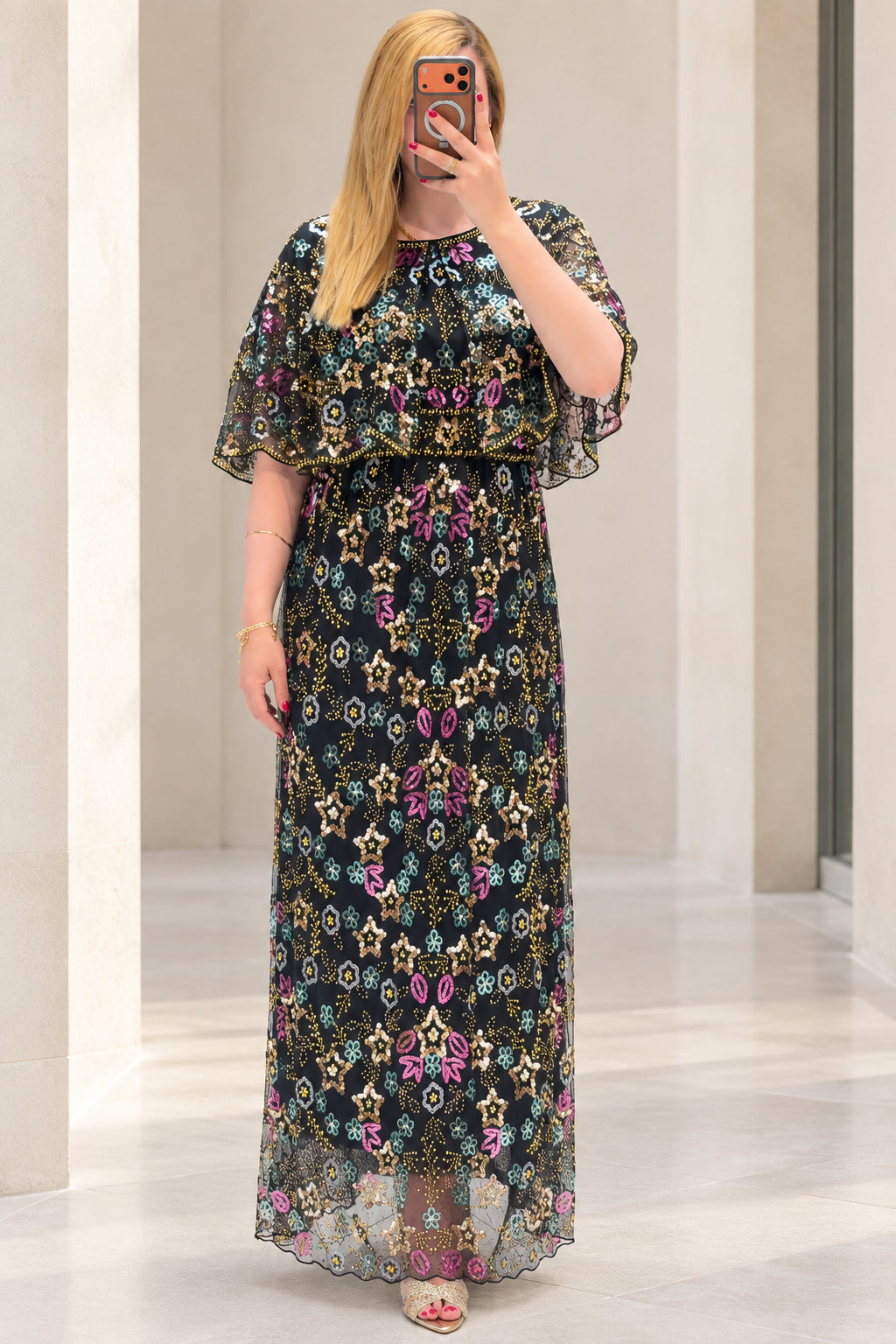 Front view of black sequin floral embroidered capelet maxi dress