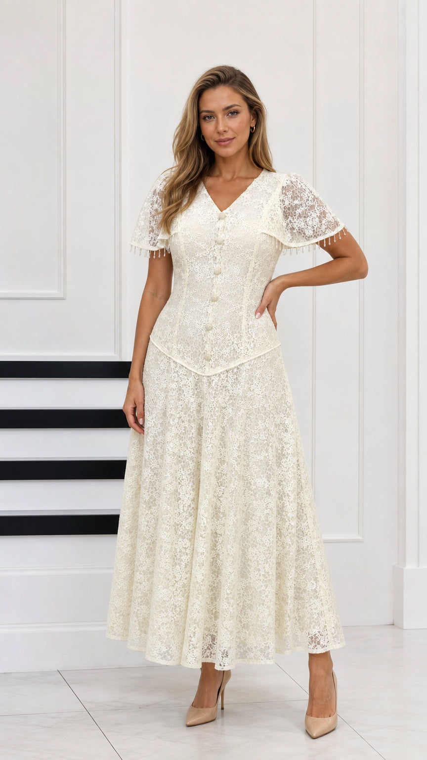 Full-length front view of cream floral lace maxi dress with capelet sleeves and button front