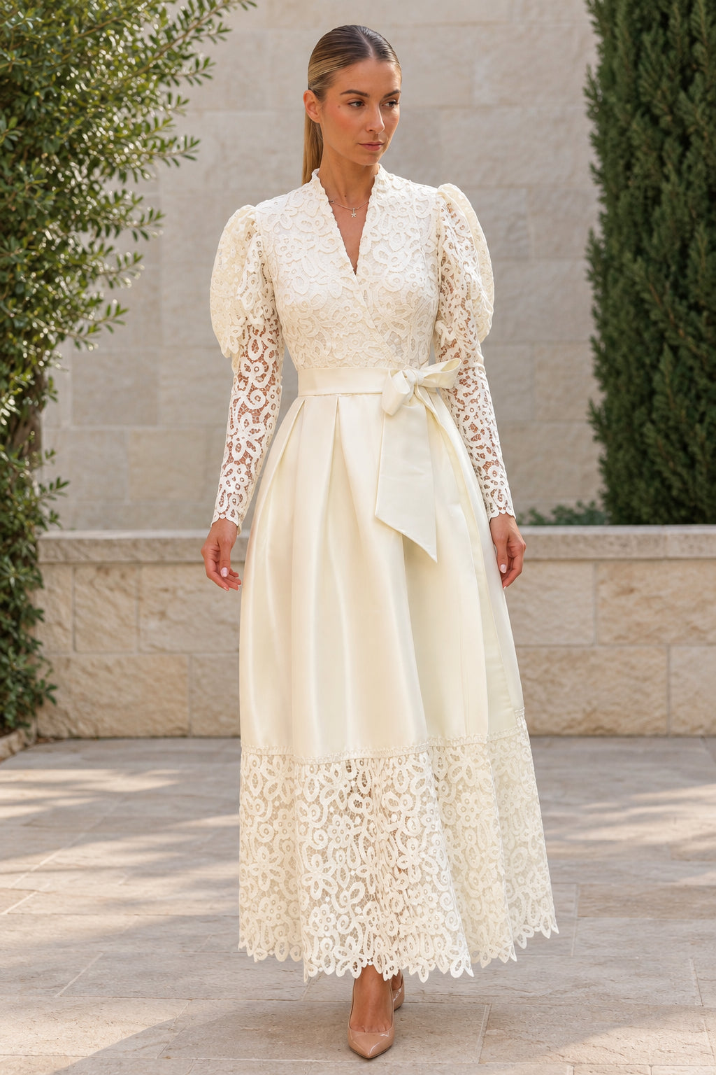 Front view of woman wearing ivory floral lace puff sleeve belted satin maxi dress