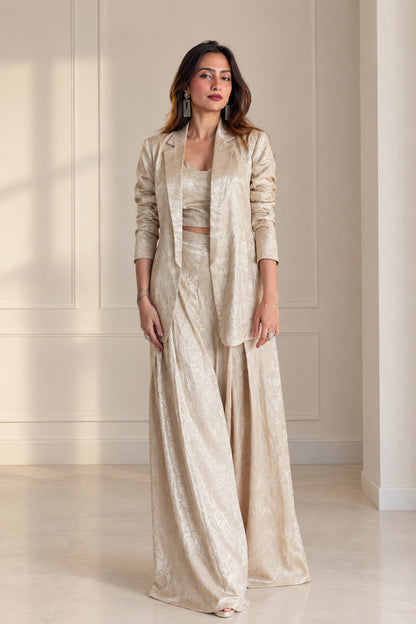 Front view of model wearing Champagne 3-piece textured jacquard suit set with blazer, crop top, and wide-leg pants