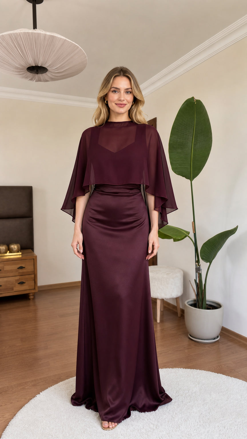 Front view of model wearing burgundy satin maxi dress with sheer capelet