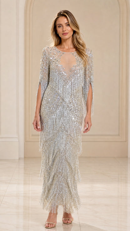 Front view of woman wearing silver sequin beaded fringe maxi gown with illusion neckline
