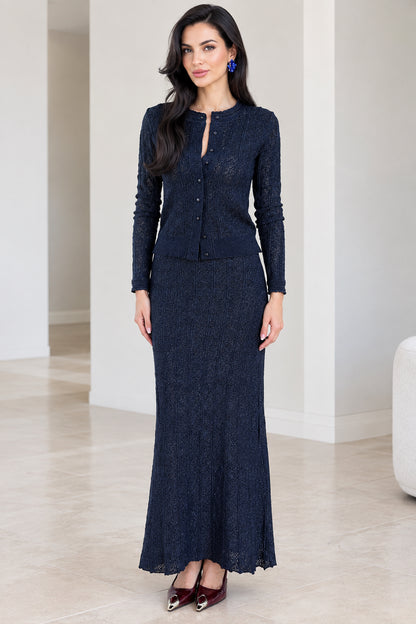 Front view of woman wearing navy blue textured knit cardigan and maxi skirt set
