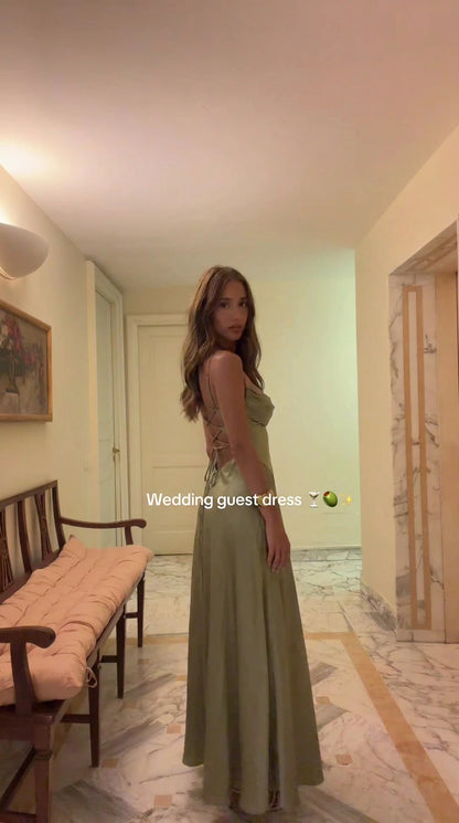 Model wearing Sage Green satin cowl neck maxi dress with lace-up back - side angle