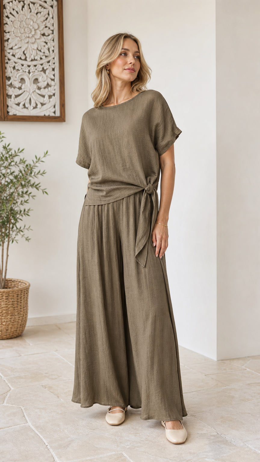 Model wearing olive green two-piece set with side-tie short sleeve top and wide-leg pants front view