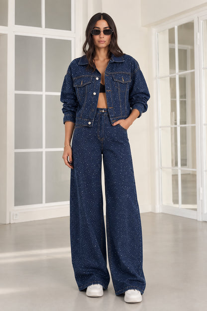 Front view of model wearing dark blue rhinestone cropped denim jacket and wide-leg jeans set