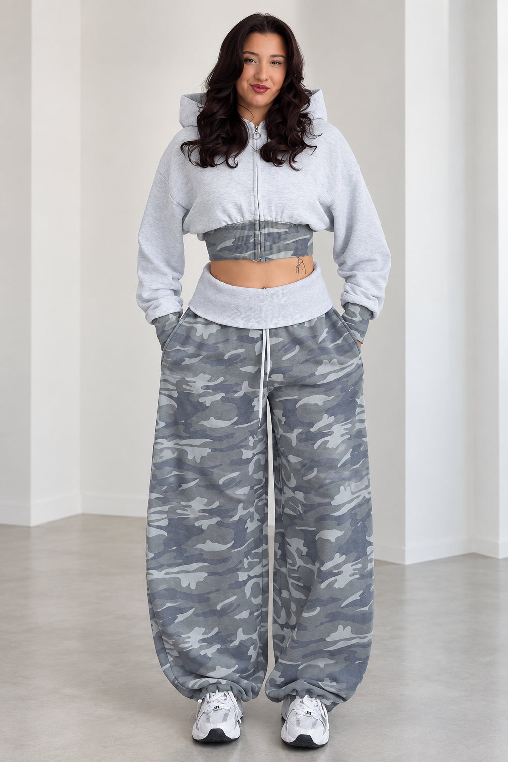 Front view of model wearing Heather Grey cropped zip hoodie and wide leg camo sweatpants set