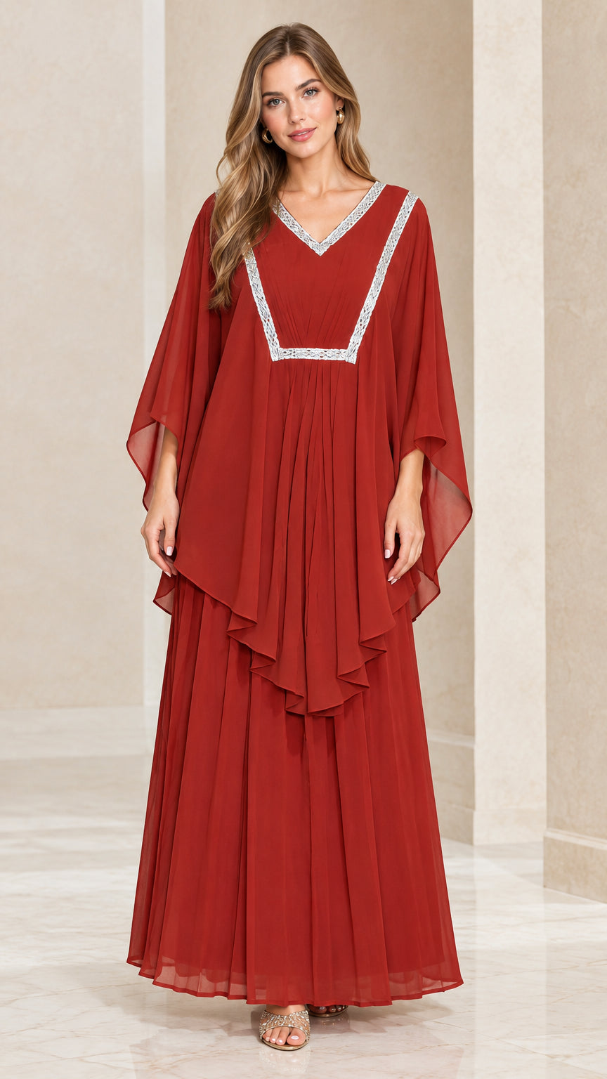 Front view of woman wearing rust red layered kaftan maxi dress with silver embroidered V-neck