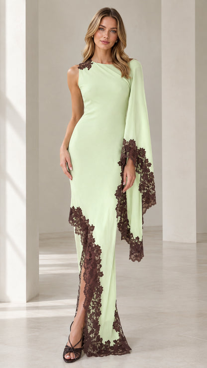 Front view of woman wearing mint green asymmetric cape sleeve maxi dress with contrast brown lace trim