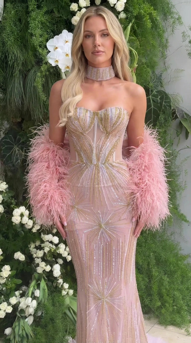 Blush pink strapless sequin beaded mermaid gown with pink feather cuffs and choker front view