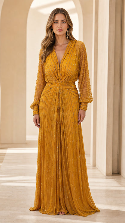 Front view of model wearing mustard yellow beaded long sleeve evening dress