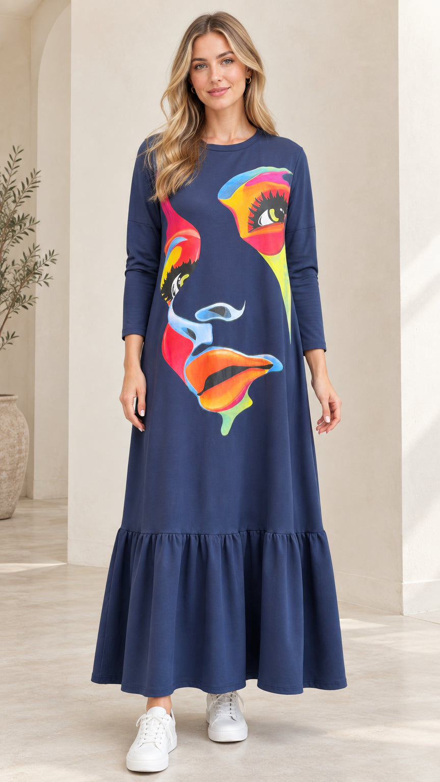 Front view of woman wearing Navy Blue abstract graphic print tiered maxi dress with white sneakers