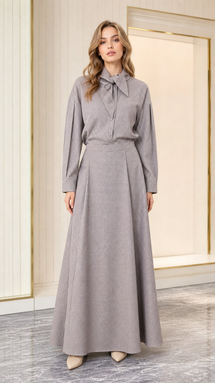 Front view of model wearing grey houndstooth tie-neck long sleeve maxi dress