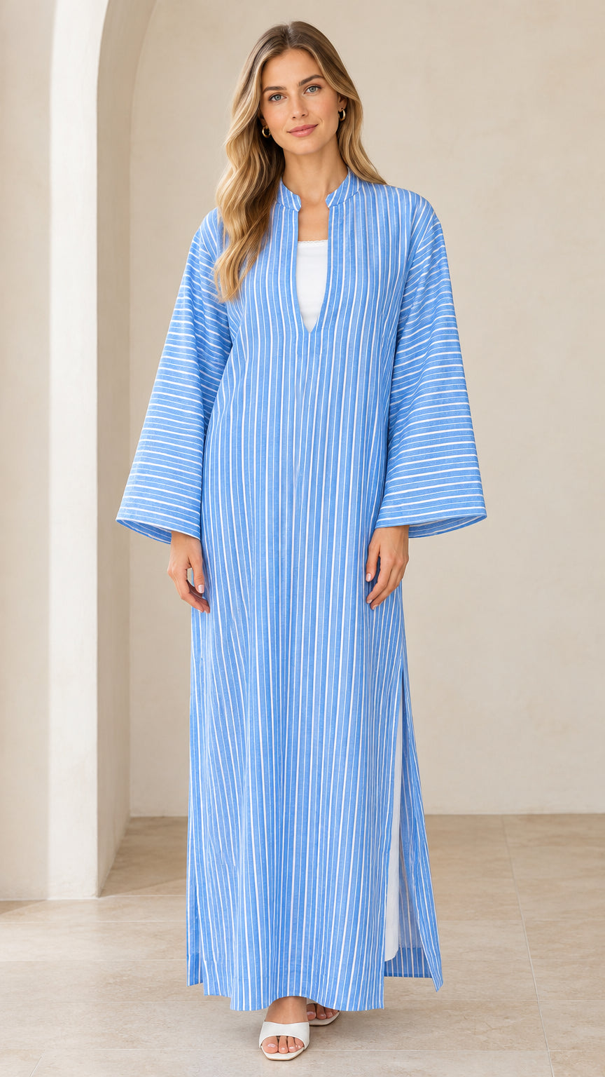Front view of woman wearing sky blue striped maxi kaftan dress