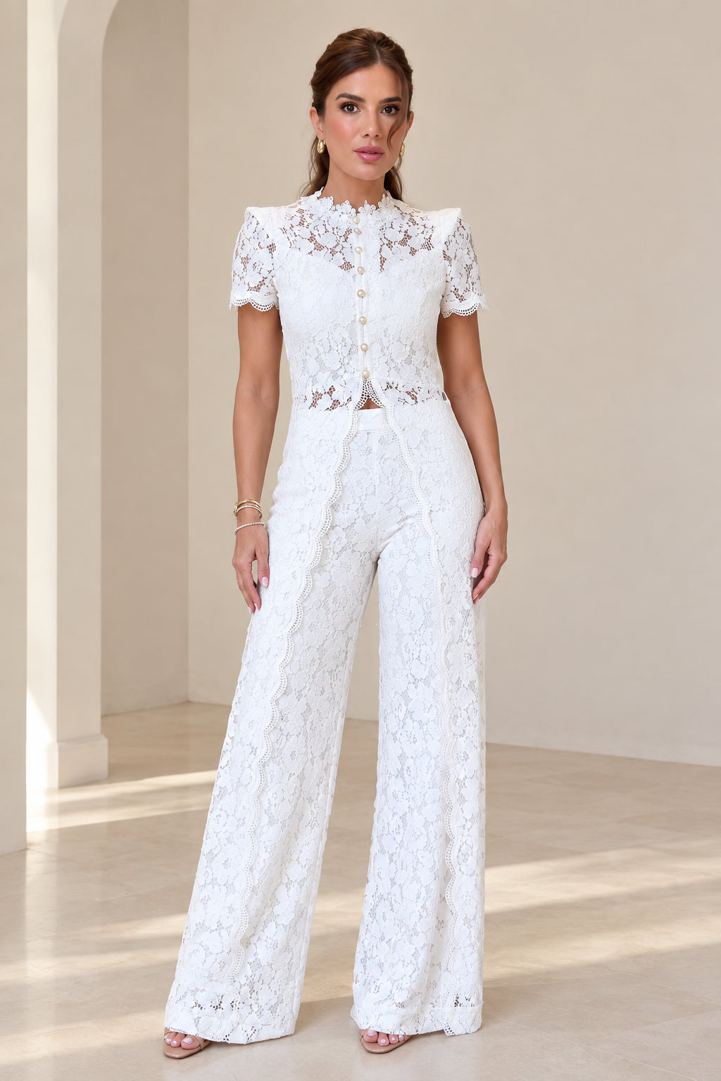 Model wearing white floral lace short sleeve top and wide leg pants two piece set front view
