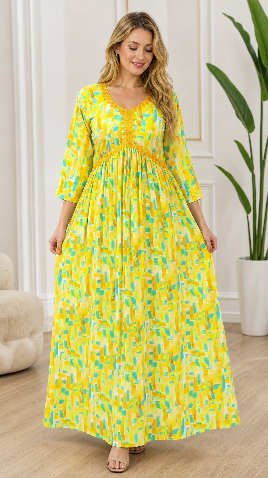 Front view of model wearing vibrant yellow abstract print empire waist maxi dress with lace trim