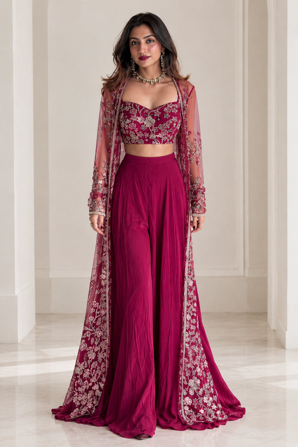 Front view of model wearing magenta 3-piece set with embroidered crop top, wide-leg palazzos, and floor-length sheer cape