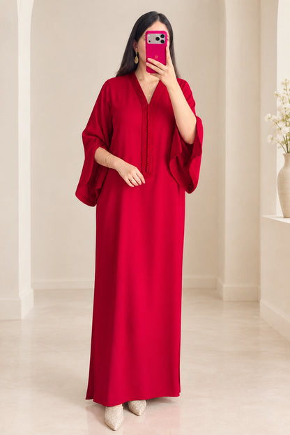 Front view of woman wearing elegant red kaftan maxi dress with wide flared sleeves