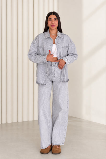 Front view of model wearing light blue striped denim shirt jacket and wide leg pants set
