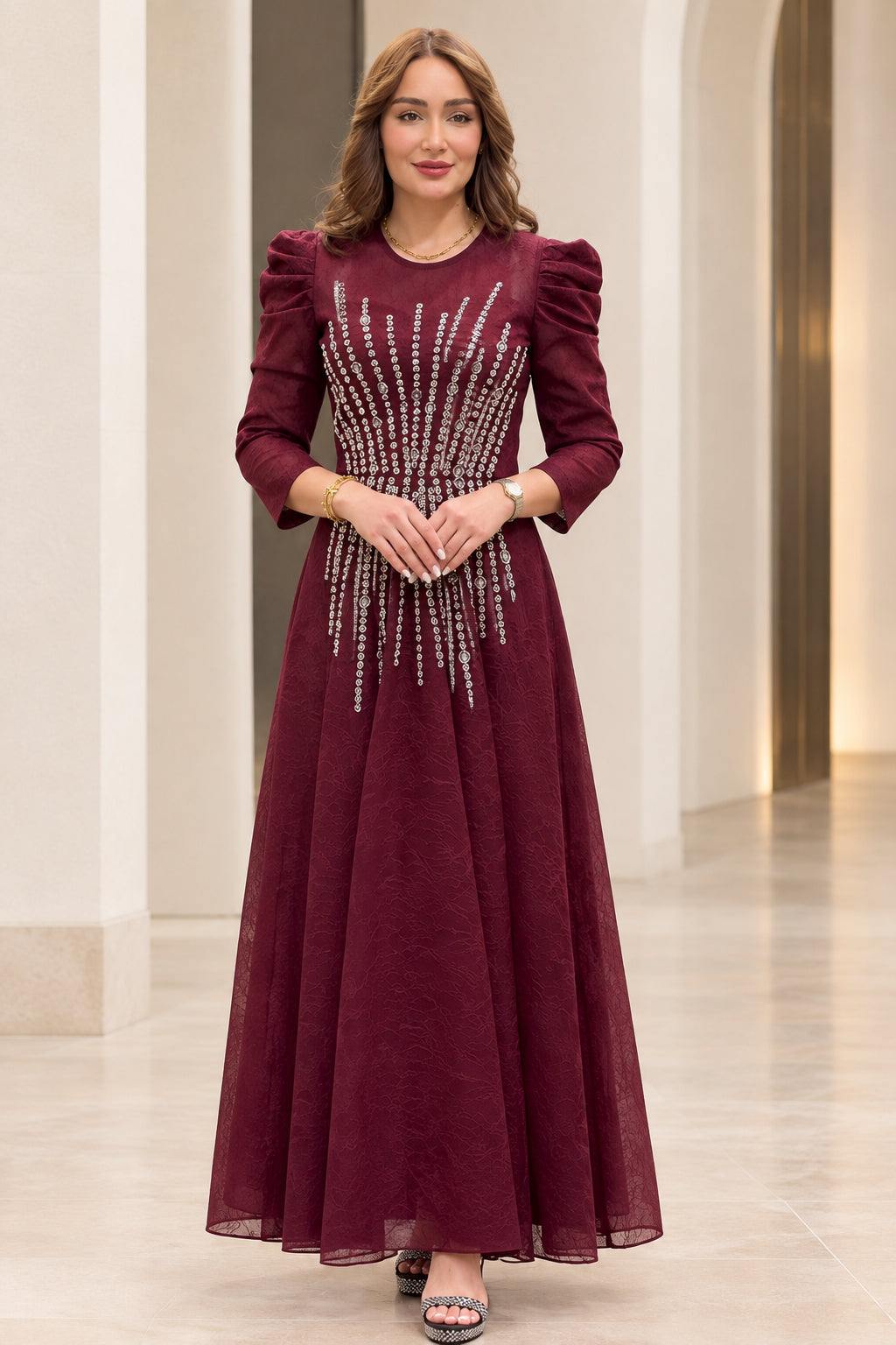 Front view of model wearing burgundy rhinestone embellished puff shoulder maxi dress