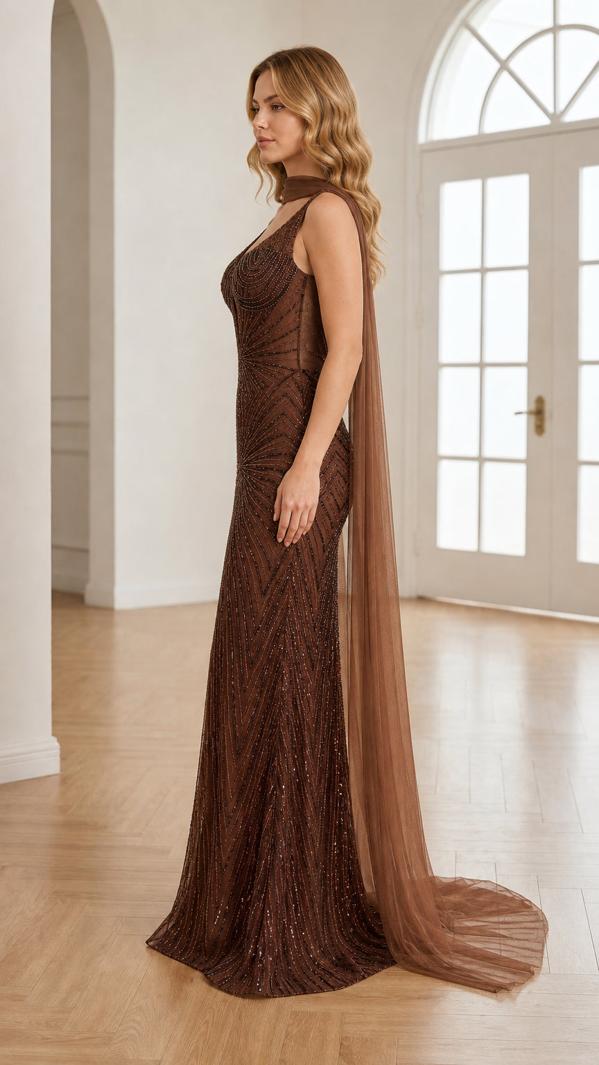 Side profile view of model wearing chocolate brown floor-length cape dress