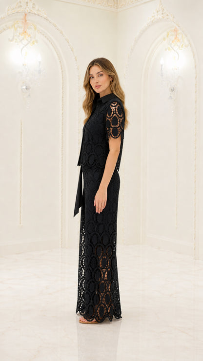 Side full-length view of woman modeling black lace two-piece pants set with waist sash