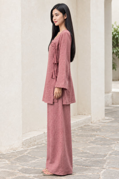 Side view of woman in Dusty Rose long-sleeve side-tie tunic top and matching trousers