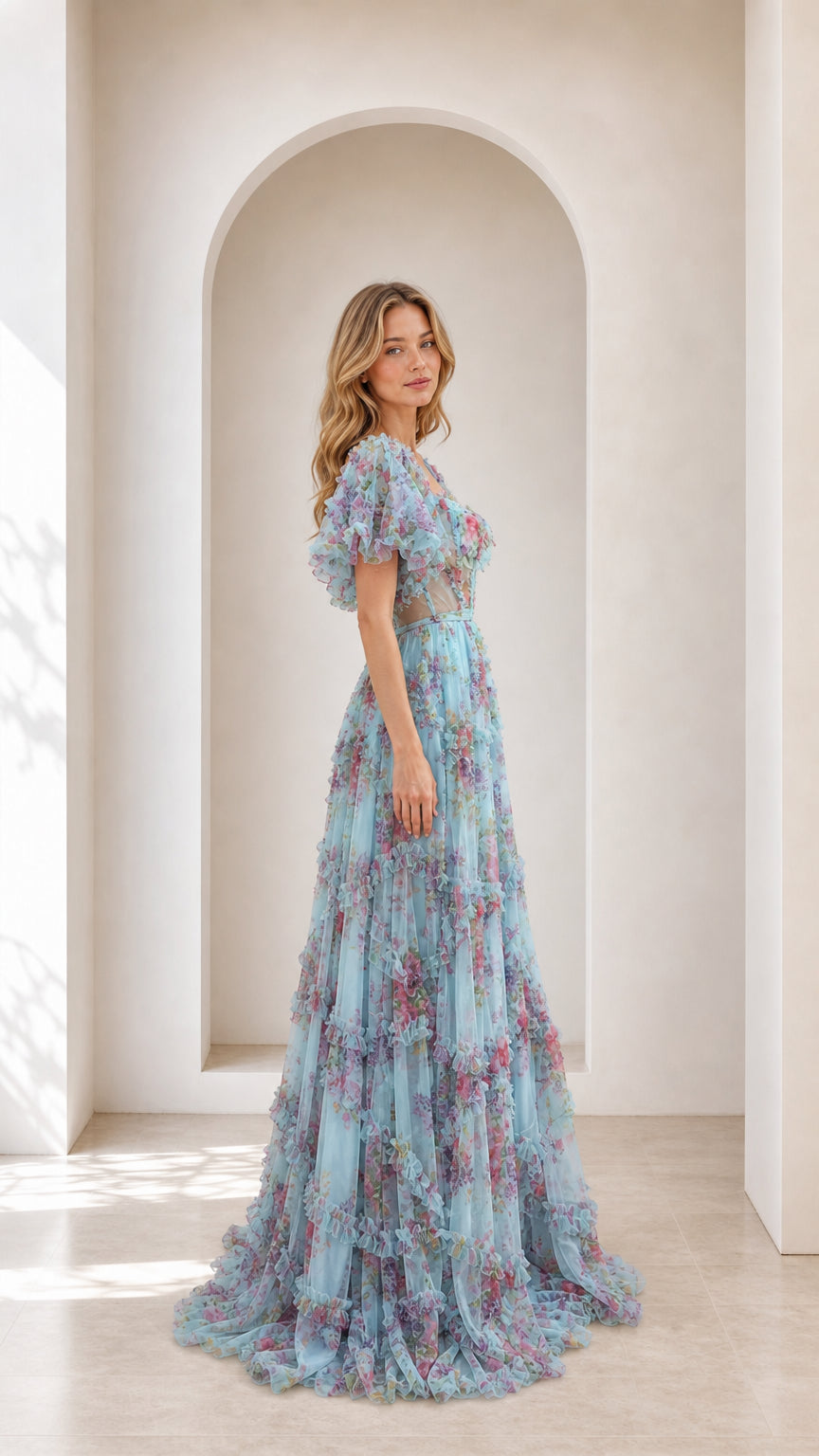 Side profile view of light blue floral tulle ball gown with puff sleeves