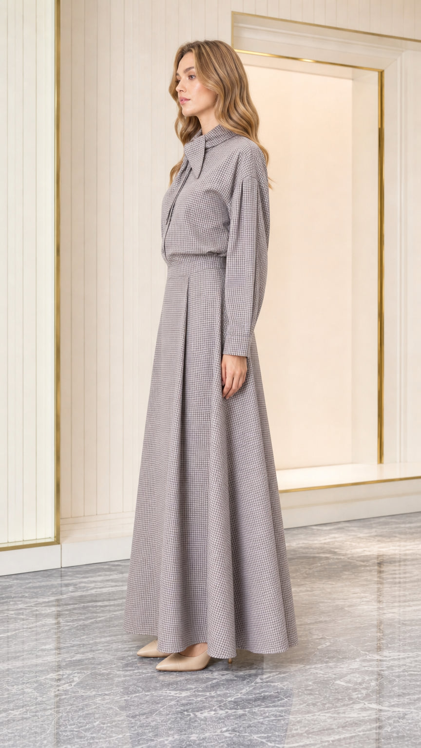 Side profile of model wearing grey houndstooth tie-neck maxi dress