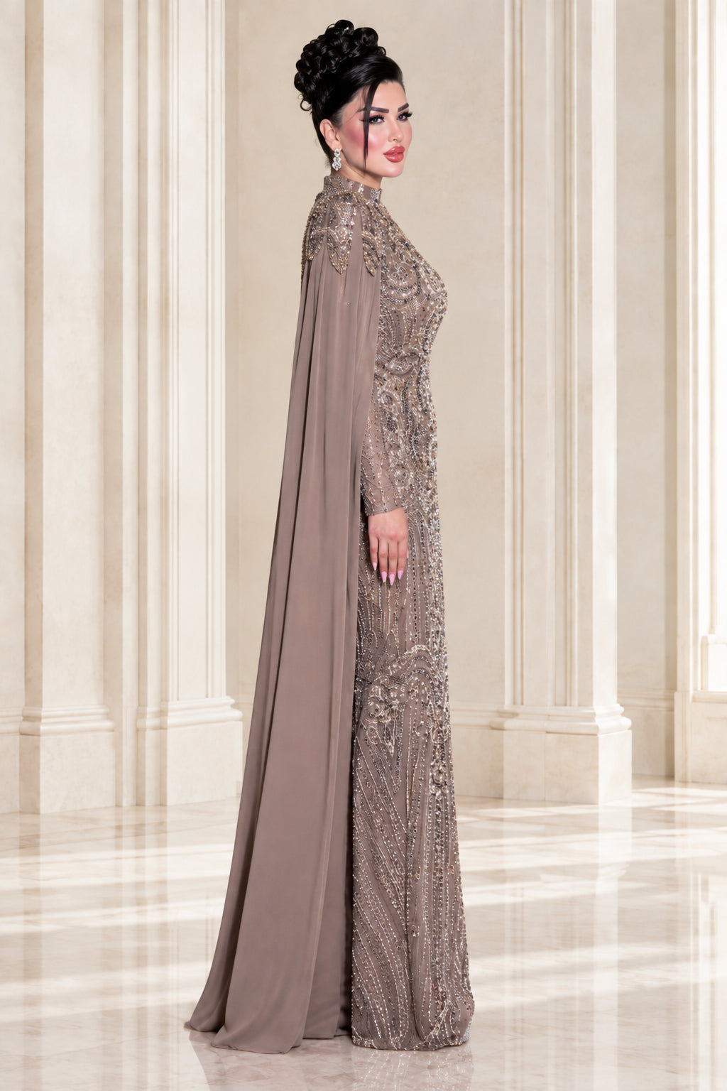 Side profile view of taupe embellished cape formal maxi dress