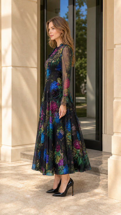 Side angle view of model wearing black floral print long sleeve evening dress