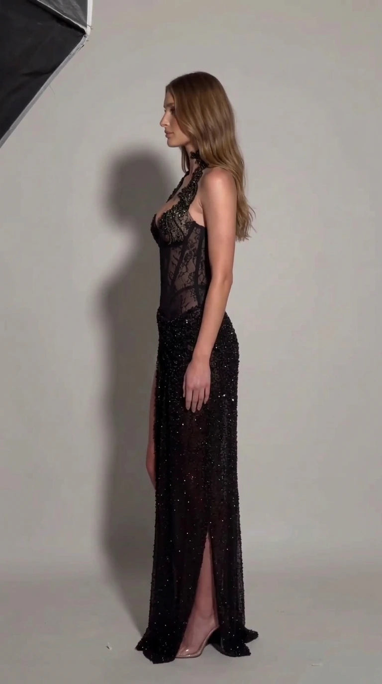 Side profile of model in black sheer lace corset beaded formal gown