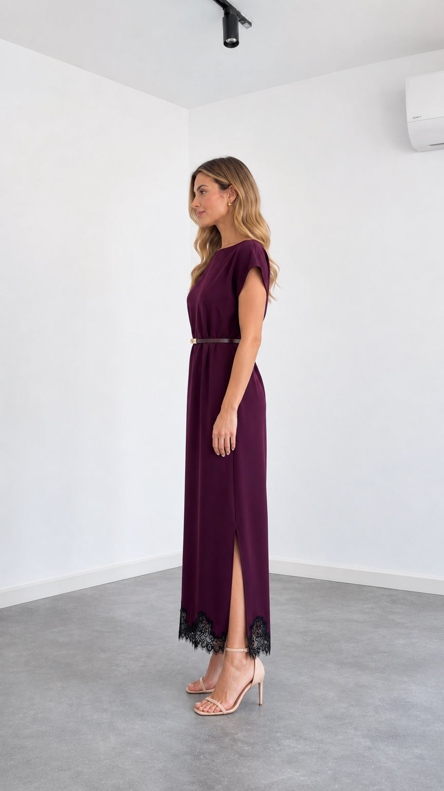 Side angle view of burgundy belted maxi dress with side slit