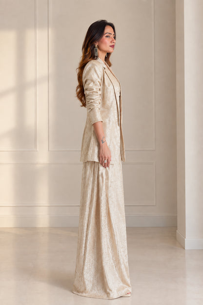 Side profile view of model wearing Champagne 3-piece jacquard pant suit set