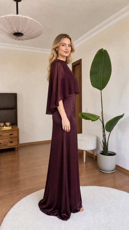 Side angle of model in burgundy capelet formal maxi gown
