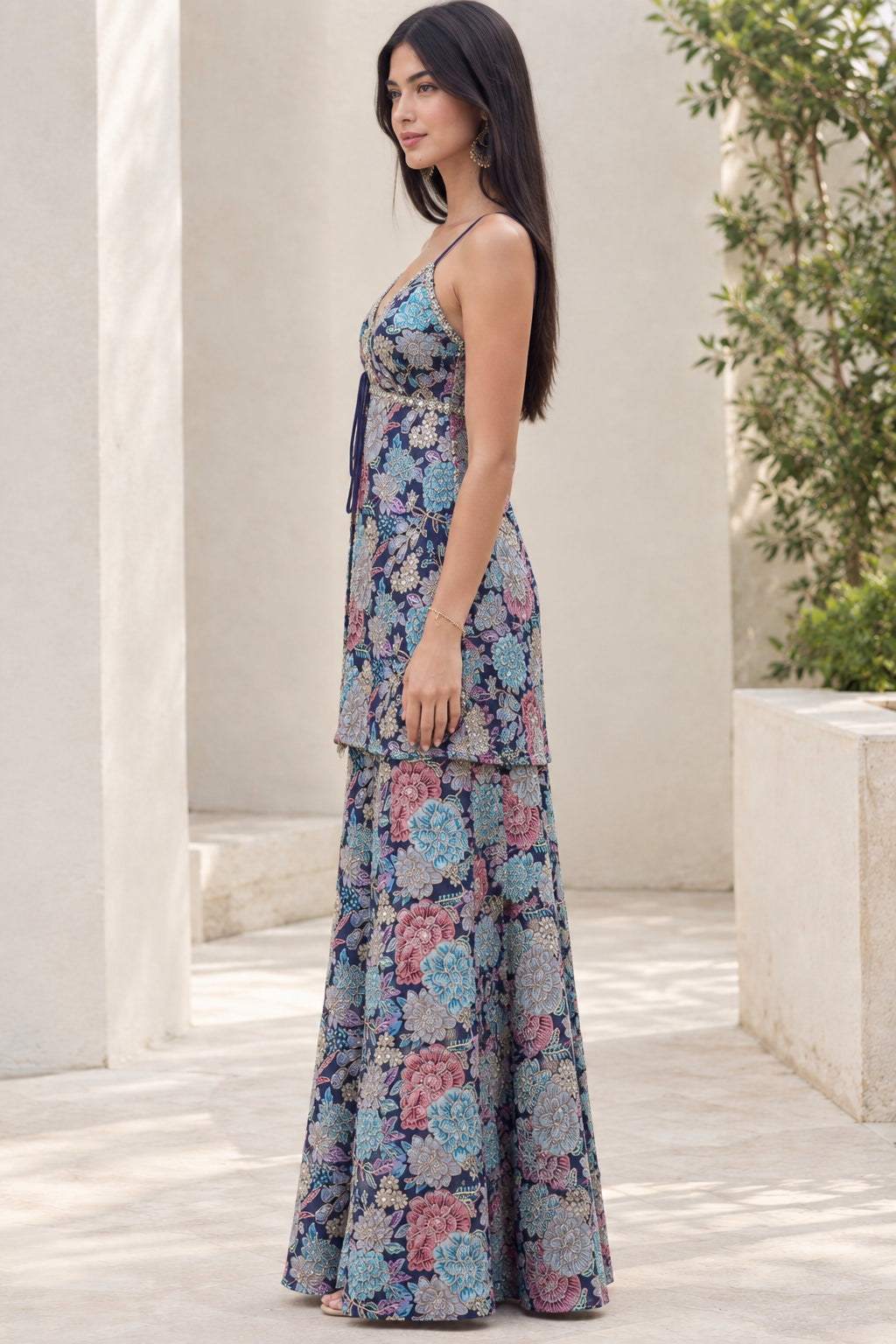 Side angle view of model in Navy Blue floral camisole tunic and matching palazzo trousers