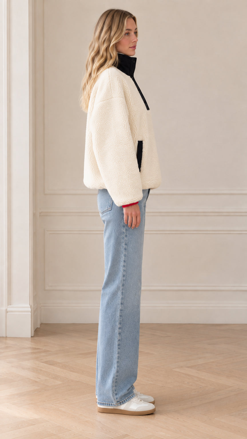 Side profile view of model wearing cream fleece pullover sweatshirt