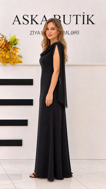 Side profile of black cowl neck formal maxi gown showing draped shoulders