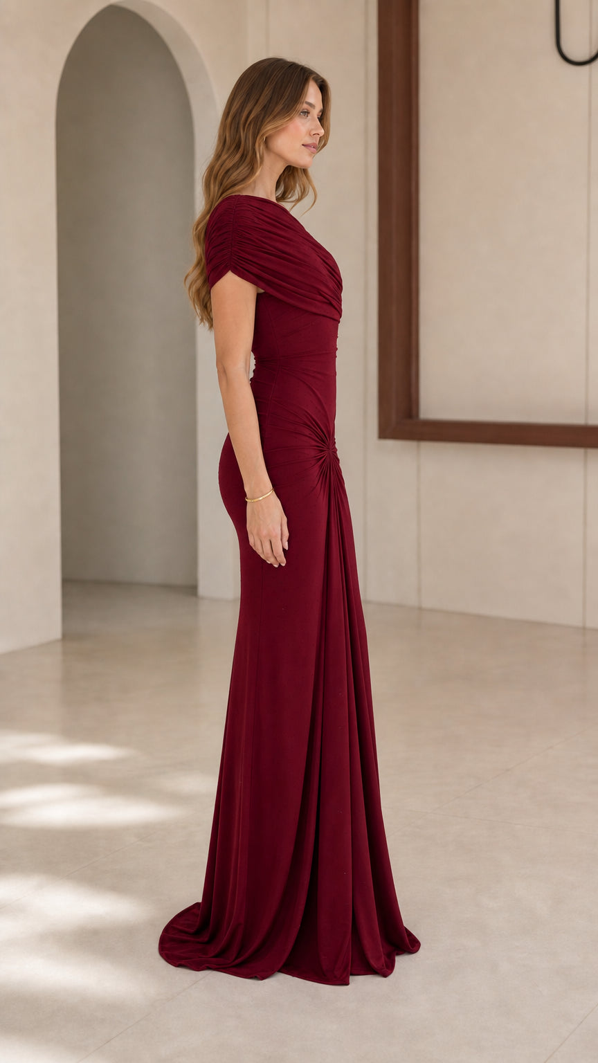 Model wearing Burgundy one-shoulder evening gown, side view