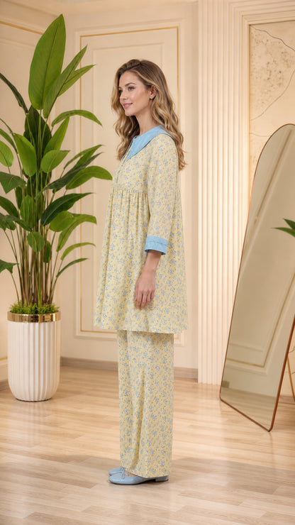 Side view of model in pastel yellow floral tunic pajama set