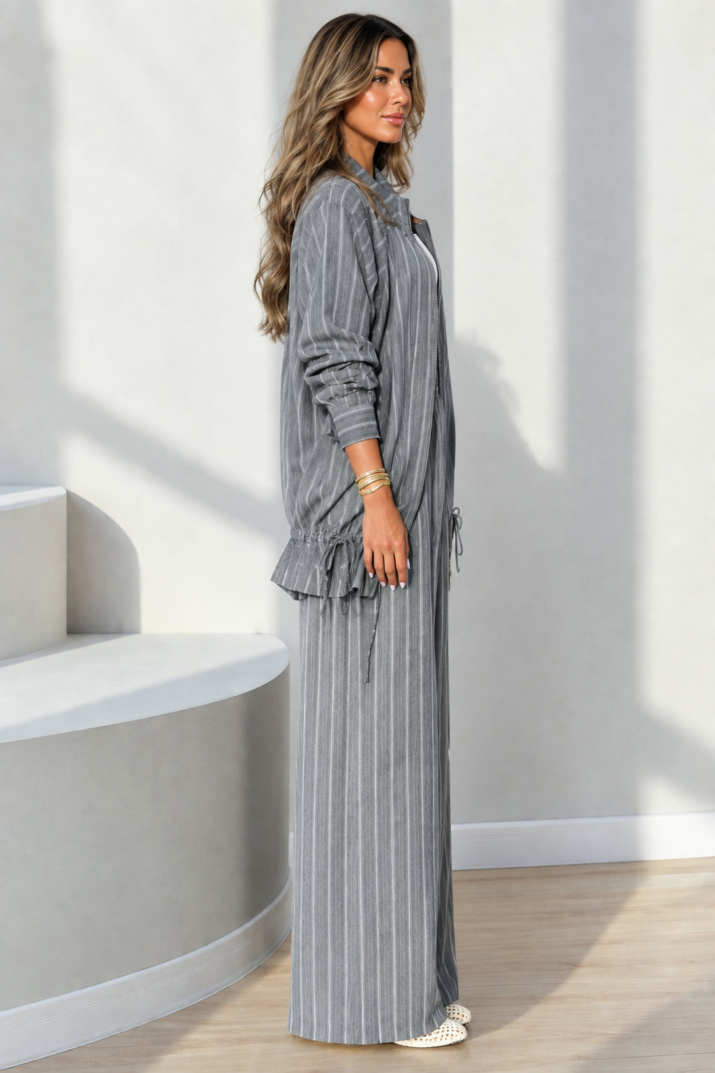 Side full-length view of grey pinstripe two-piece casual set