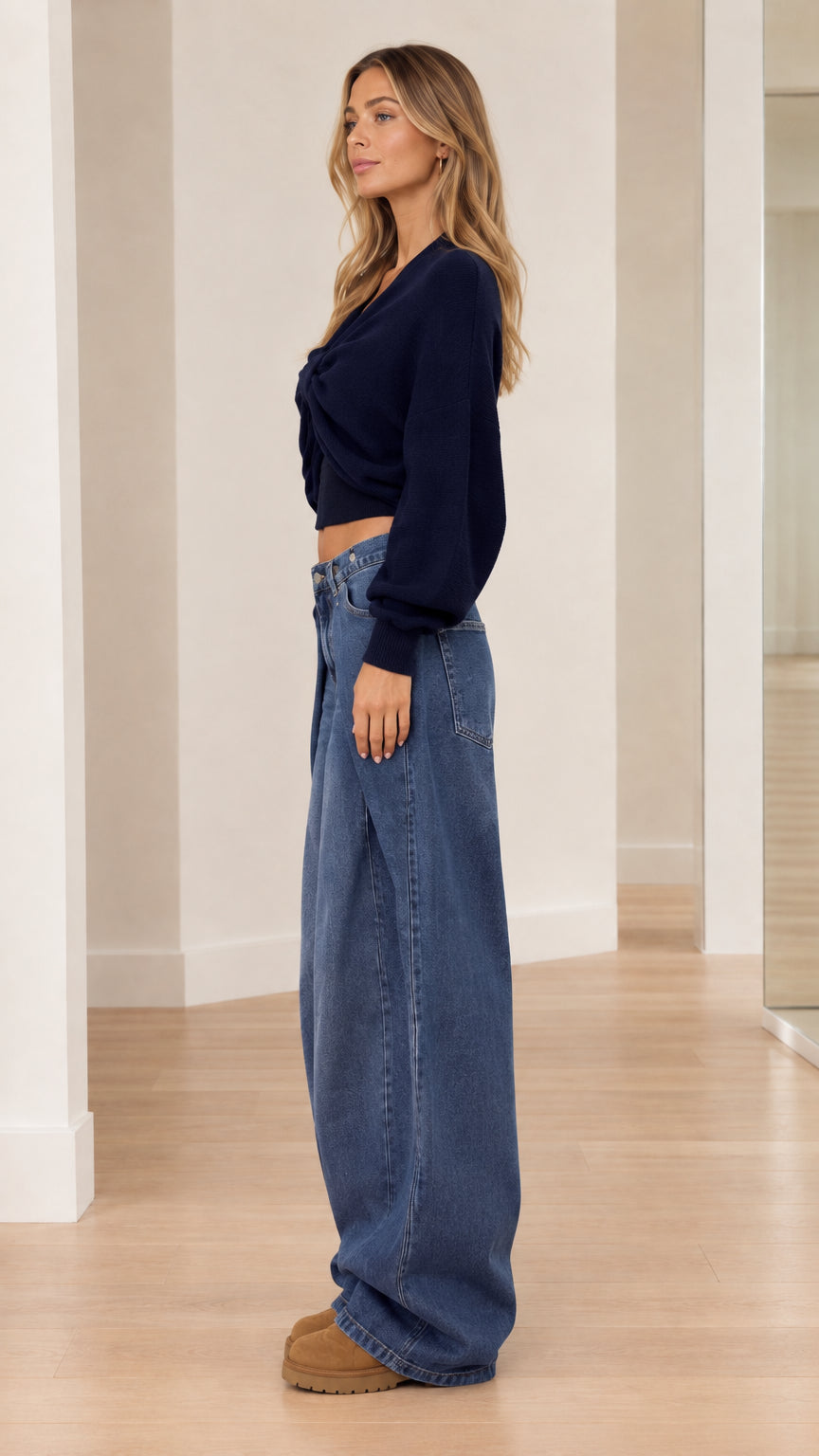 Side profile view of model wearing Navy Blue cropped knit sweater