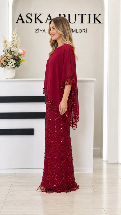 Side view of burgundy sequin capelet evening gown