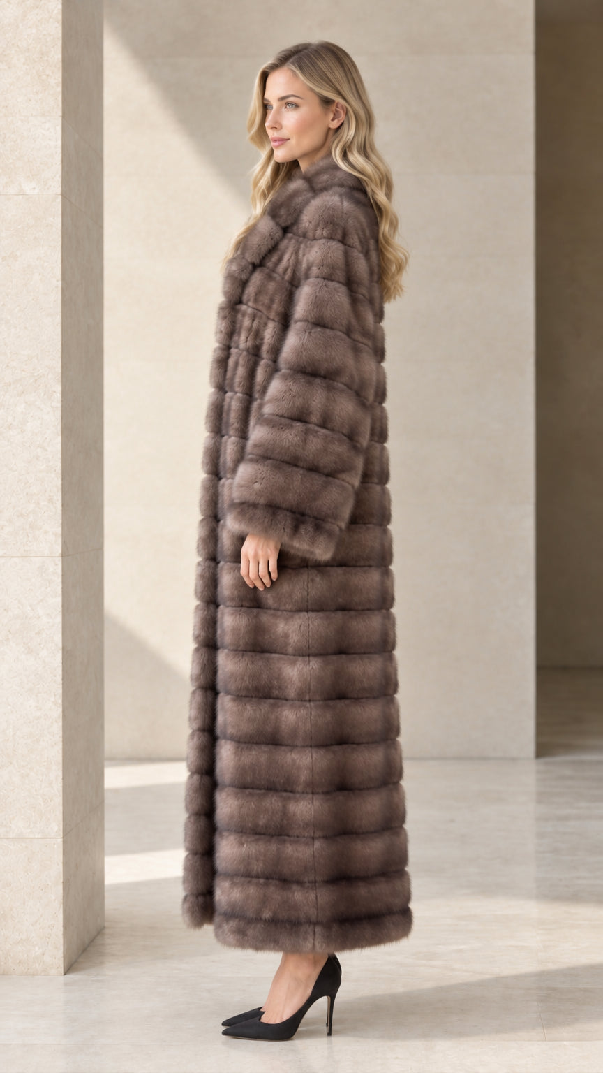 Side profile view of model wearing a taupe full-length faux fur tiered coat