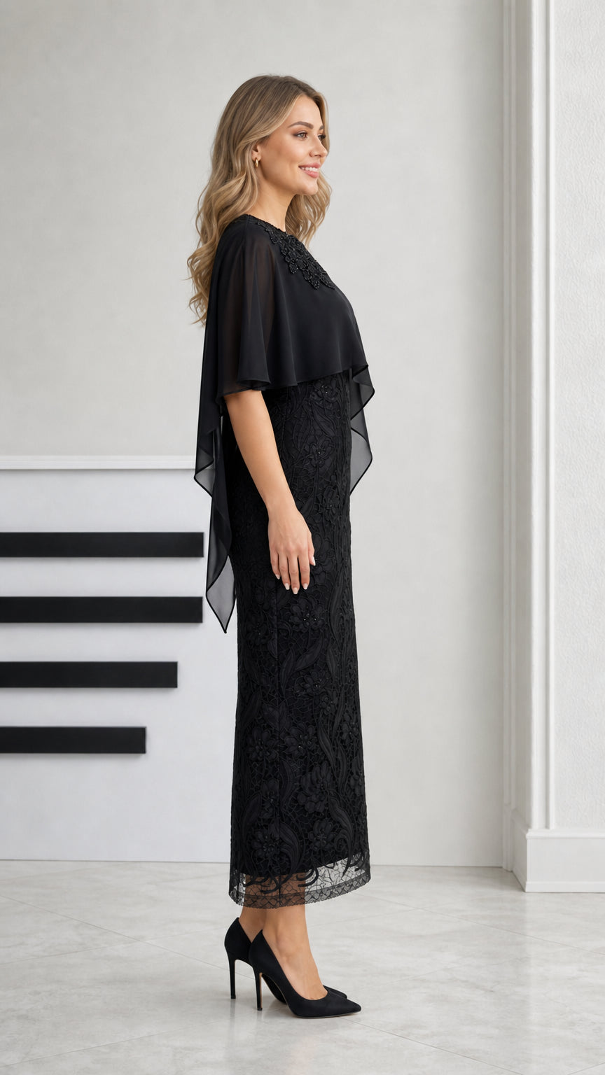 Side profile view of black formal capelet lace evening dress