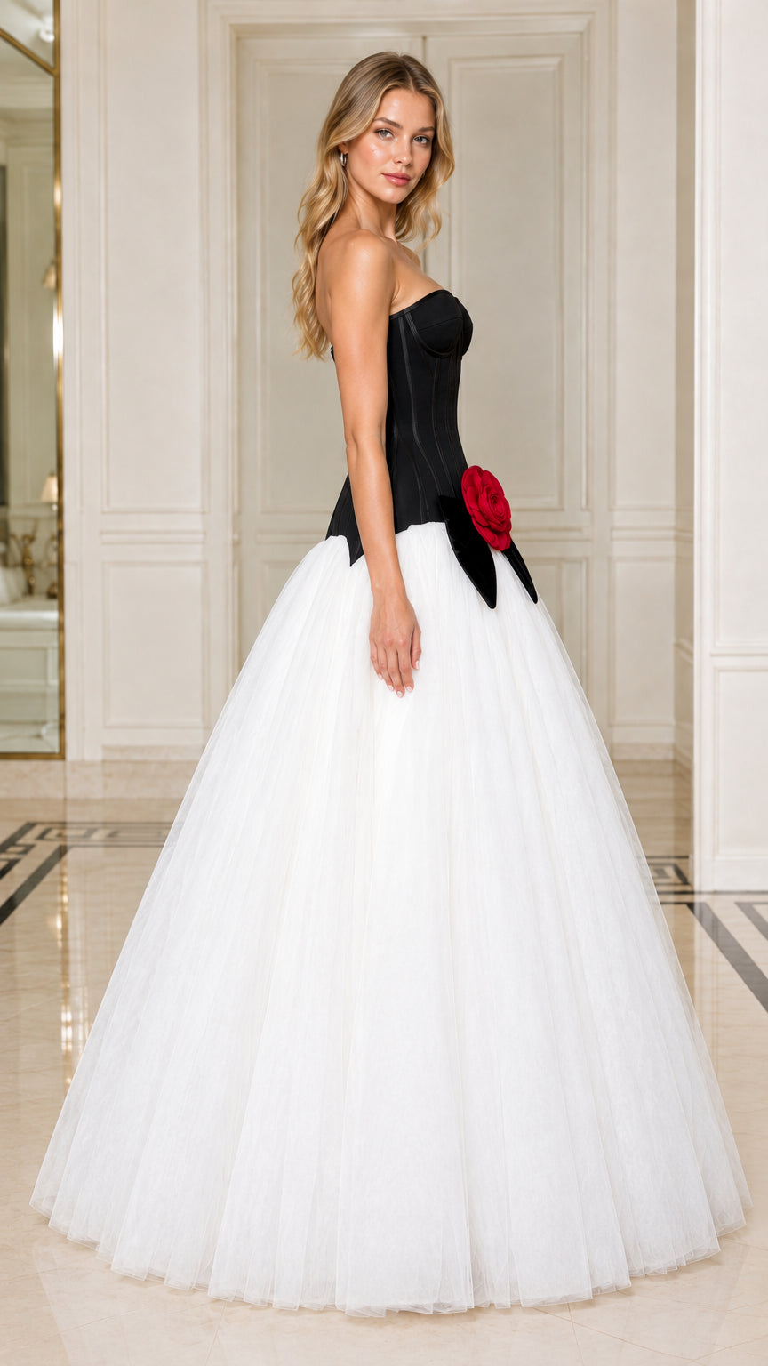Three-quarter angle view of black and white strapless tulle evening gown
