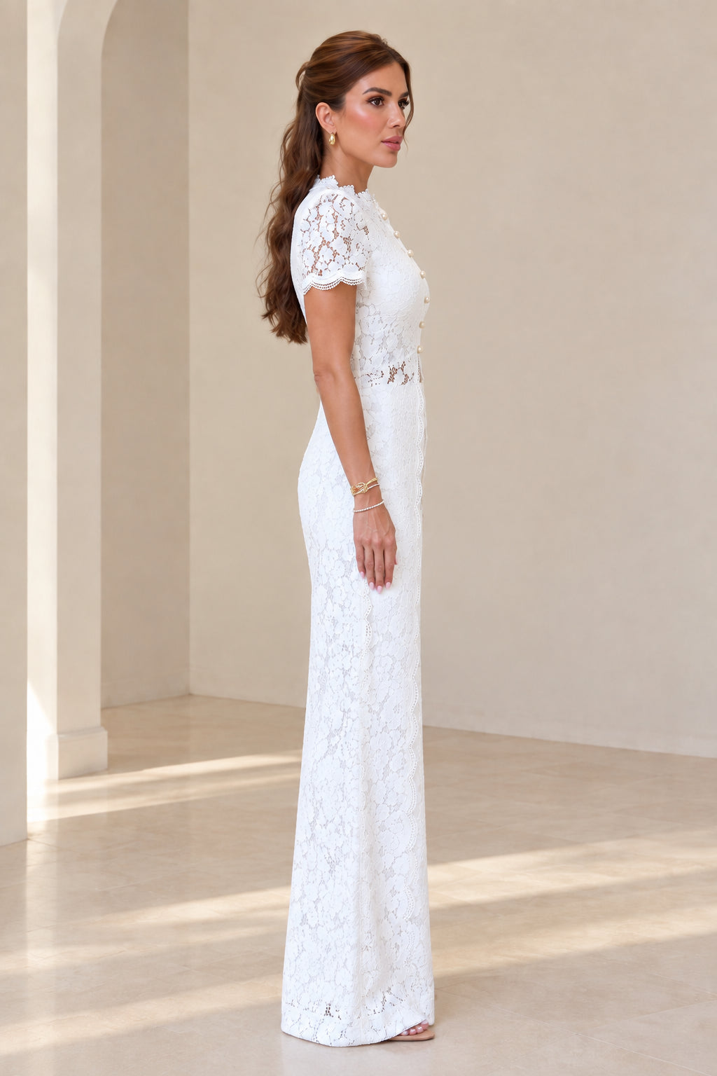 Side profile of model in white lace high waist pants set